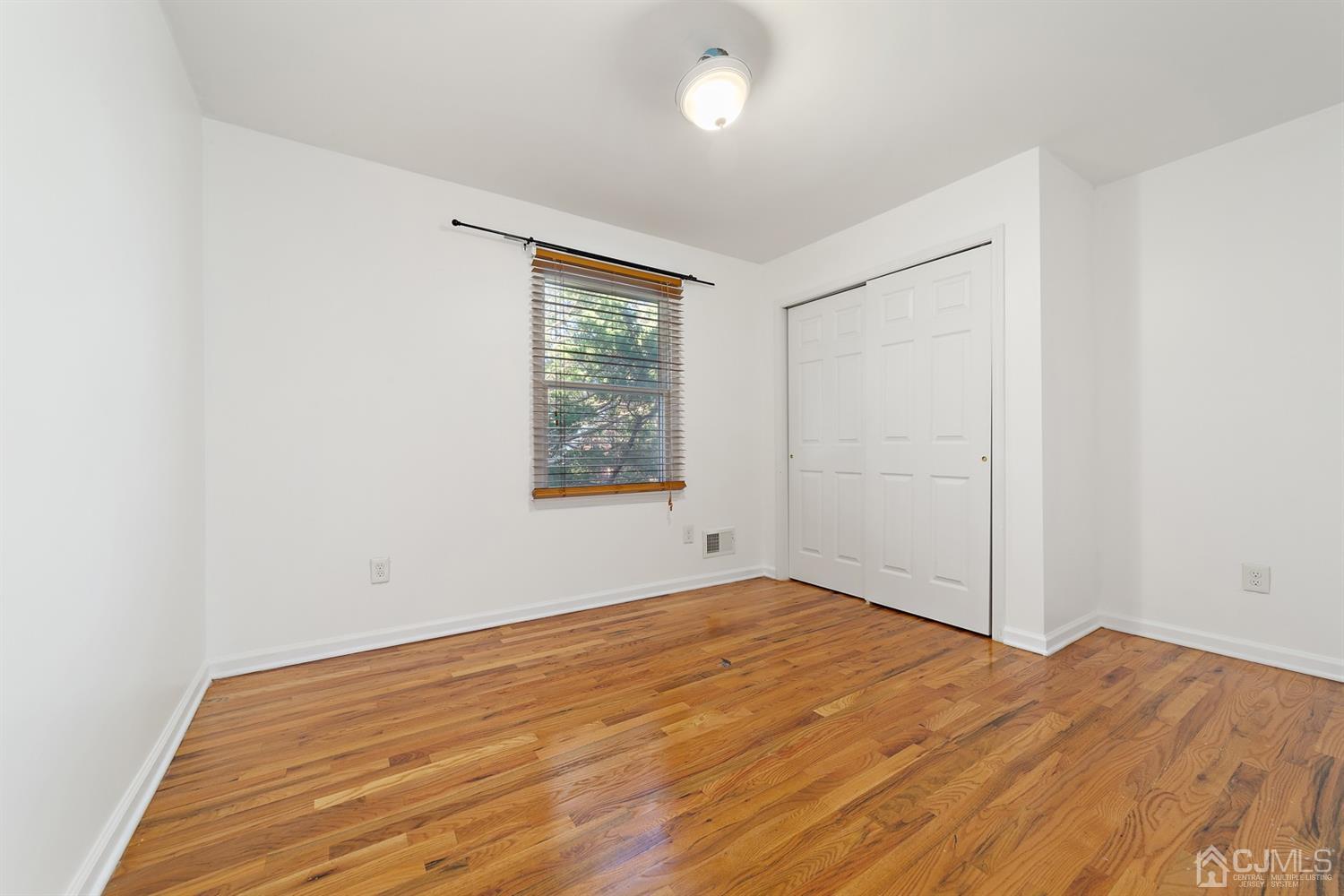 66 Helmetta Road Monroe Township, NJ 08831 - Photo 22 of 25 an empty room with wooden floor and windows