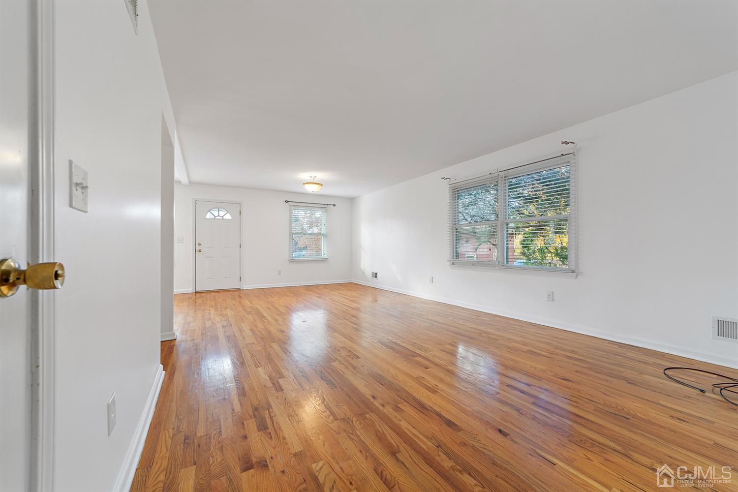 66 Helmetta Road Monroe Township, NJ 08831 - Photo 5 of 25 an empty room with wooden floor and windows