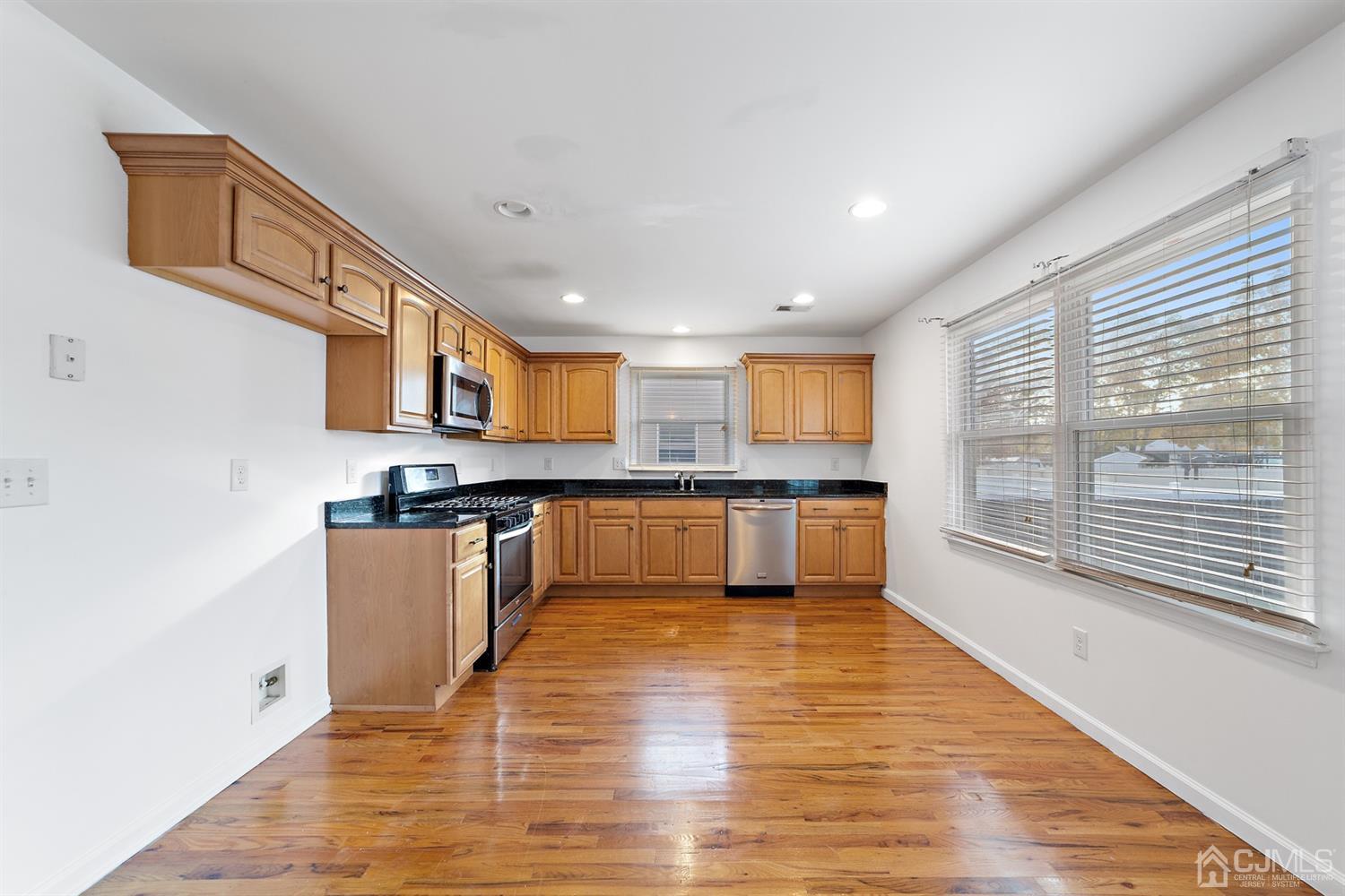 66 Helmetta Road Monroe Township, NJ 08831 - Photo 8 of 25 a large kitchen with stainless steel appliances granite countertop a stove and a wooden cabinets
