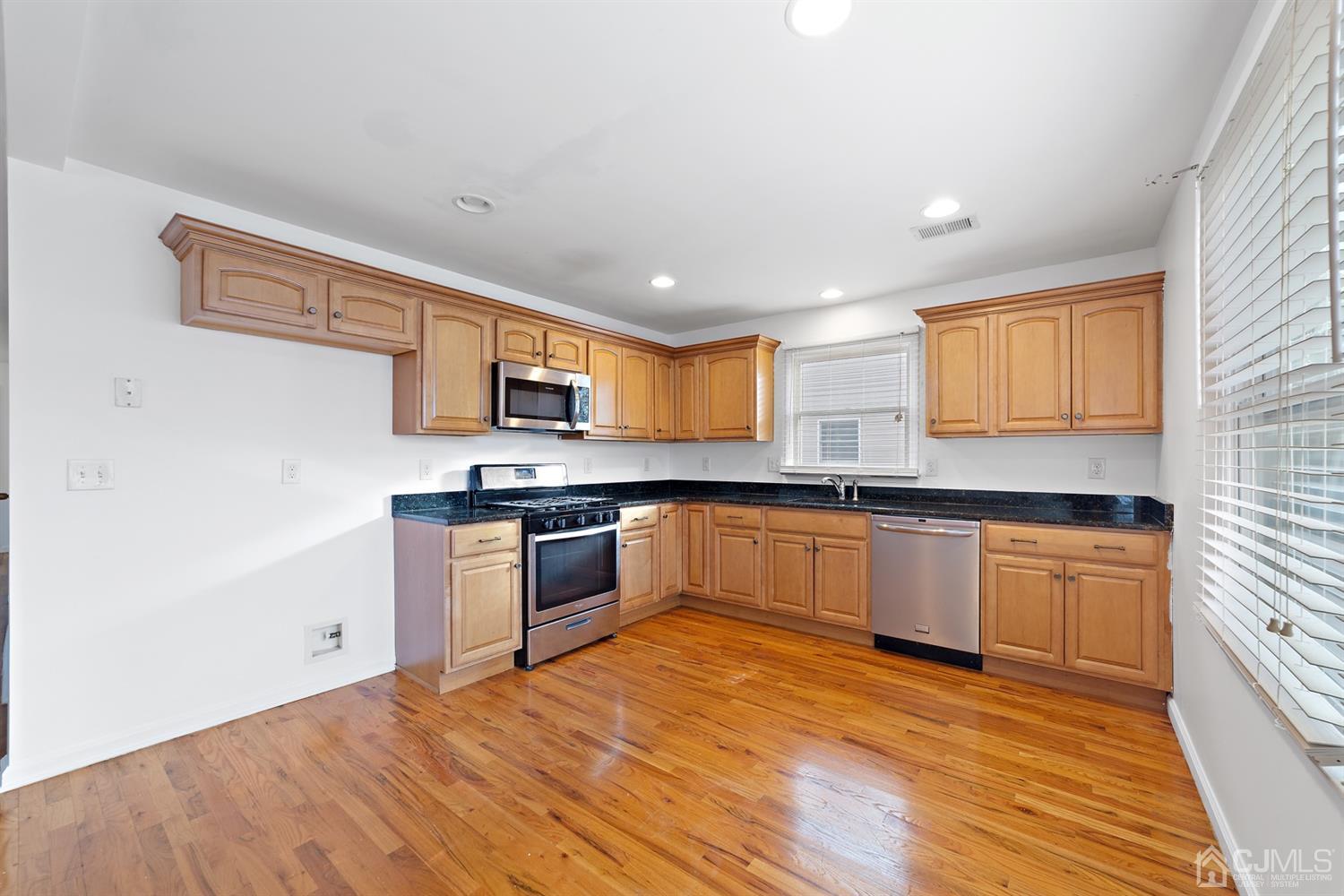66 Helmetta Road Monroe Township, NJ 08831 - Photo 9 of 25 a large kitchen with stainless steel appliances granite countertop a stove a sink and a refrigerator