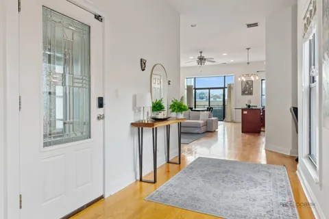a living room with furniture and a chandelier