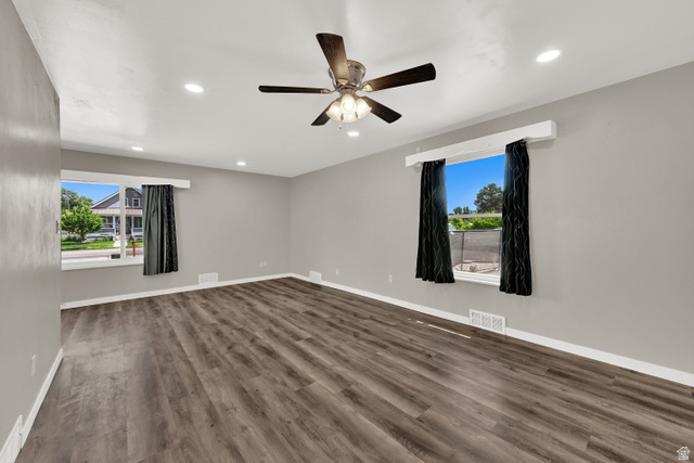 716 East Factory Street Garland, UT 84312 - Photo 6 of 30 Spacious room featuring wood-finish flooring, light grey walls, recessed ceiling lighting, and a ceiling fan with integrated light fixture