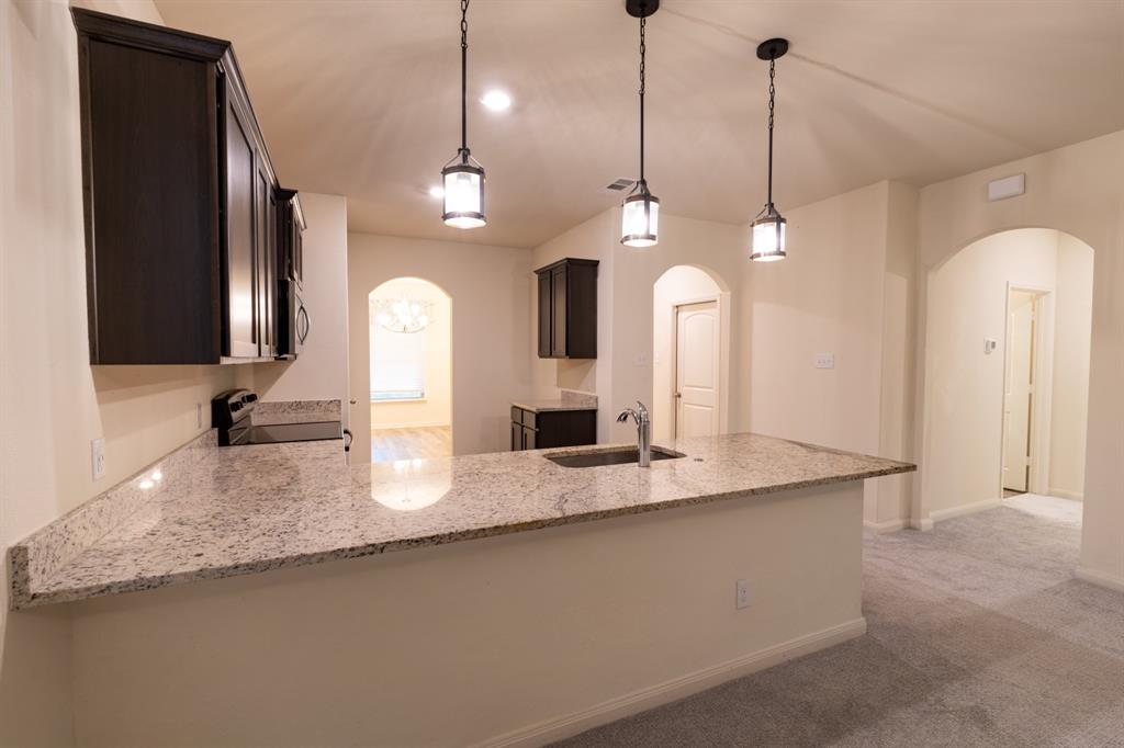 208 Liberty Lane Venus, TX 76084 - Photo 11 of 29 Large Open Kitchen With a View Into the Dining Room