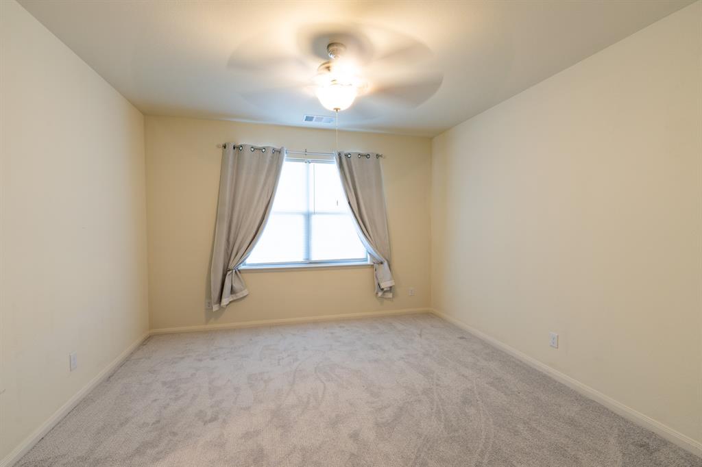 208 Liberty Lane Venus, TX 76084 - Photo 14 of 29 Large Primary Bedroom Featuring A Ceiling Fan, En-Suite Bathroom & Walk-In Closet