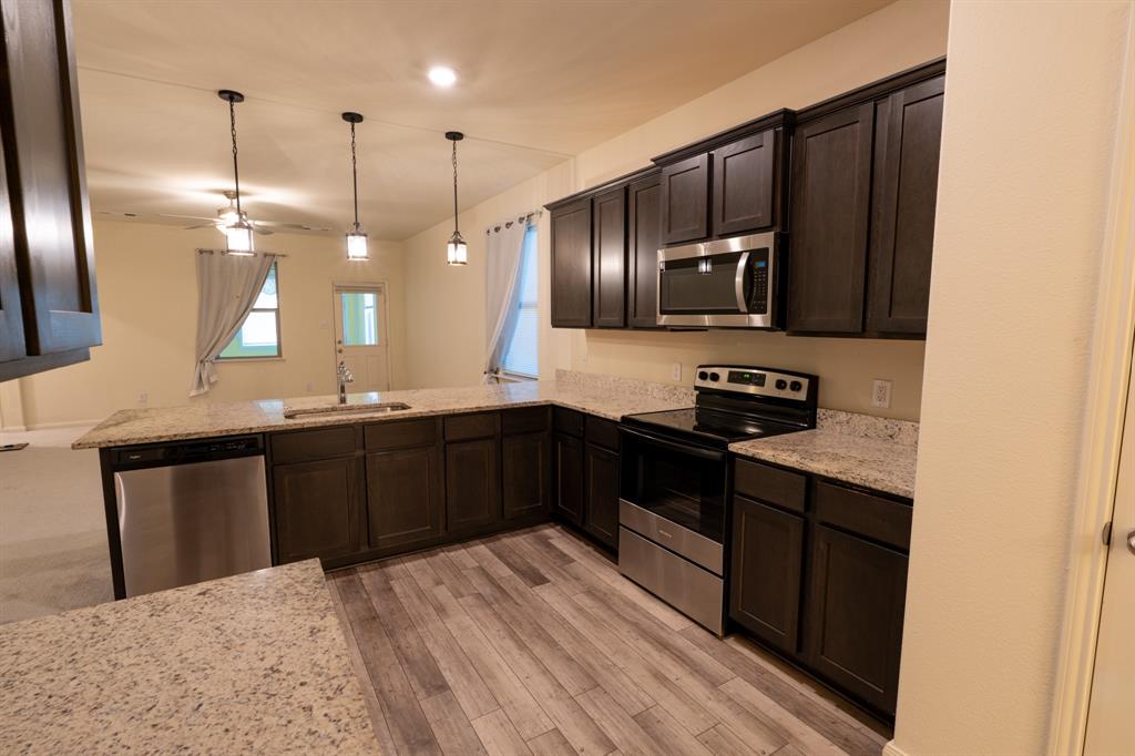 208 Liberty Lane Venus, TX 76084 - Photo 8 of 29 Kitchen Featuring Granite Countertops, Pantry & Stainless Steel Appliances (Electric Range & Dishwasher)