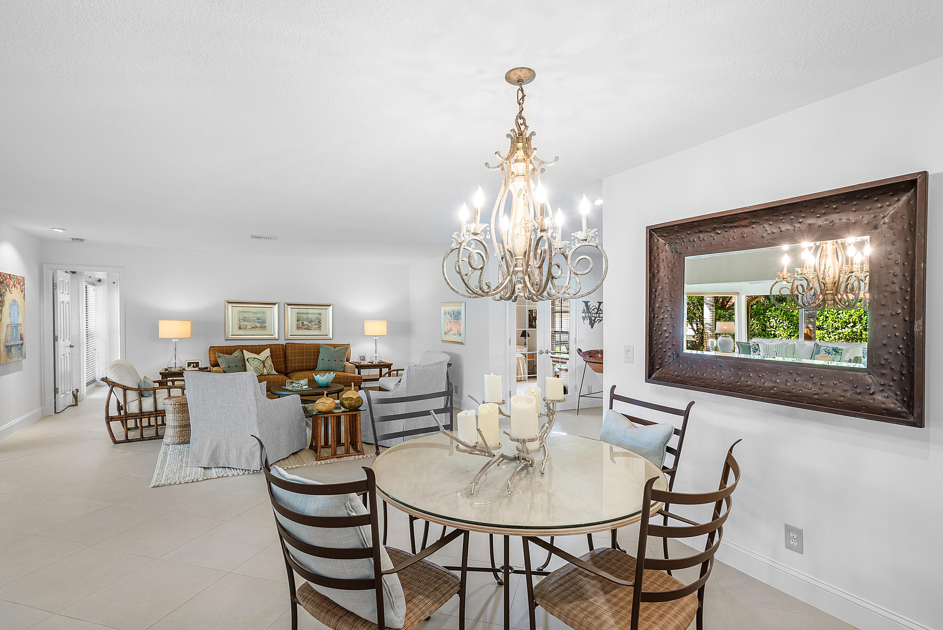 481 Forestview Drive Atlantis, FL 33462 - Photo 16 of 68 a view of a dining room with furniture a chandelier and wooden floor