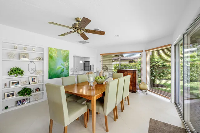a spacious bedroom with a bed a couch and a chandelier