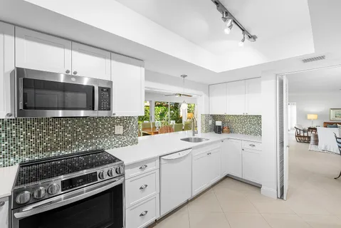 a view of a livingroom with workspace and a window