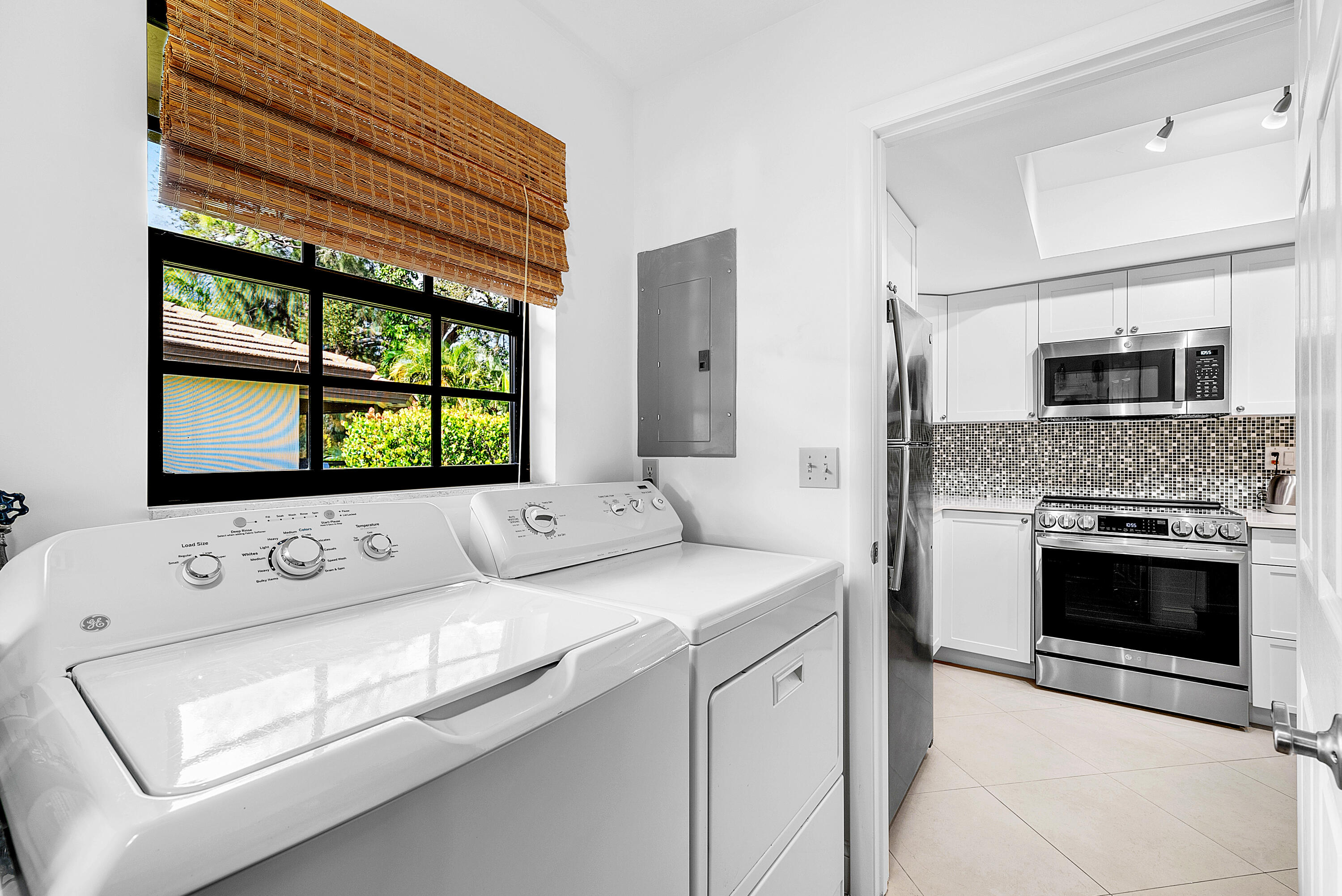 481 Forestview Drive Atlantis, FL 33462 - Photo 29 of 68 a kitchen with a stove and a microwave