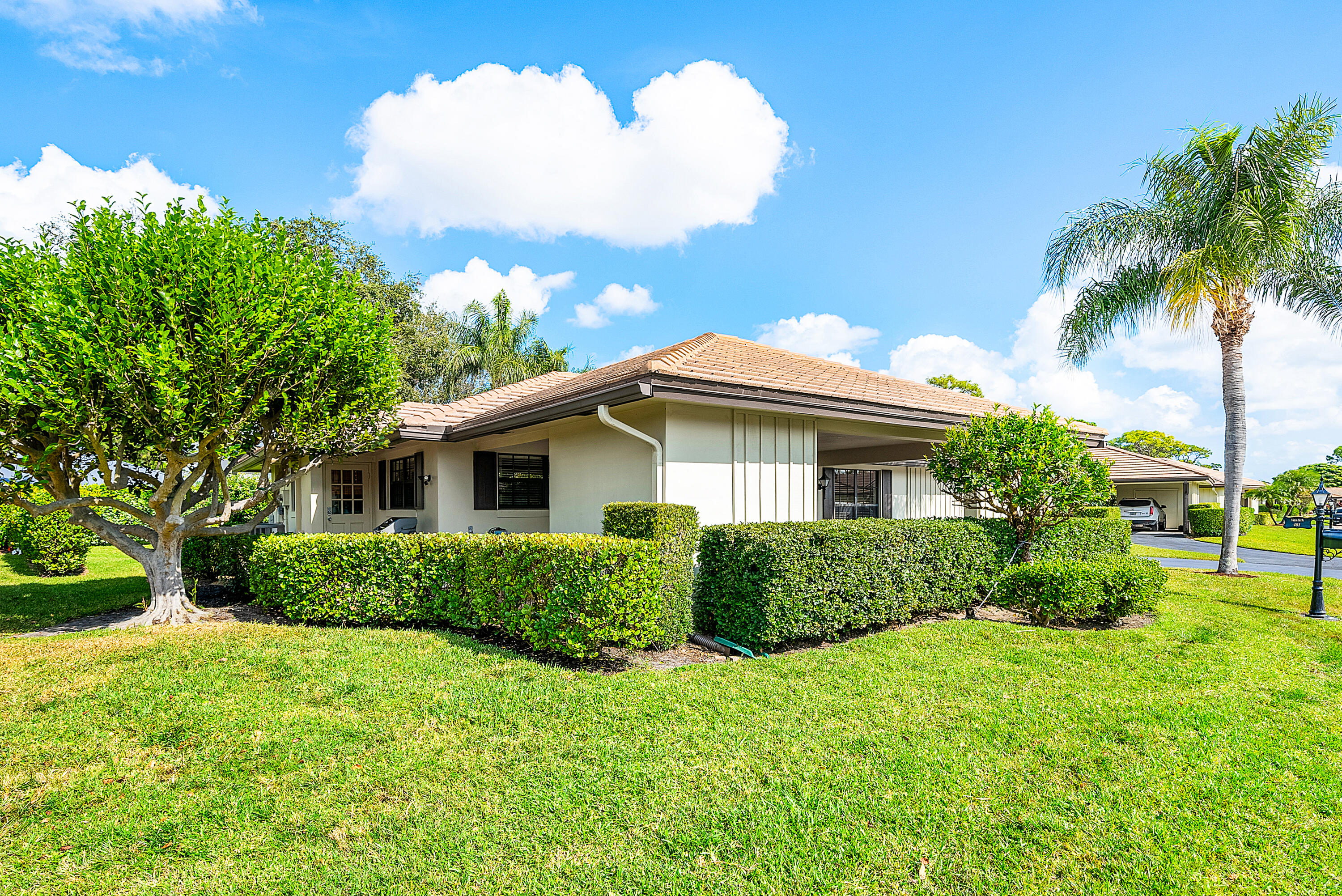 481 Forestview Drive Atlantis, FL 33462 - Photo 4 of 68 a view of a house with a big yard plants and large trees