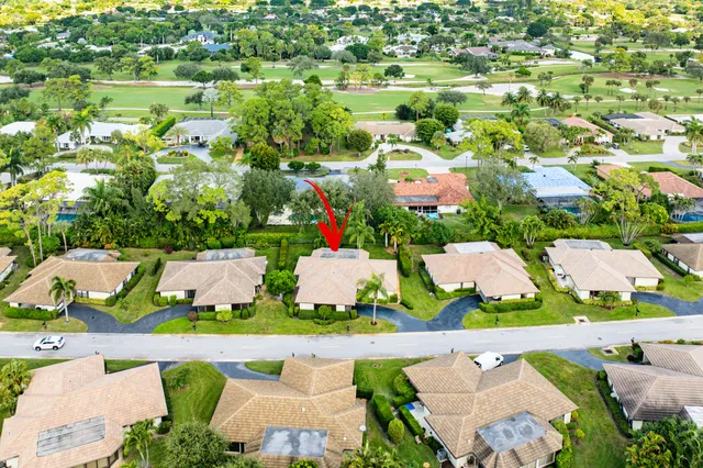 a view of a patio with table and chairs potted plants and palm tree