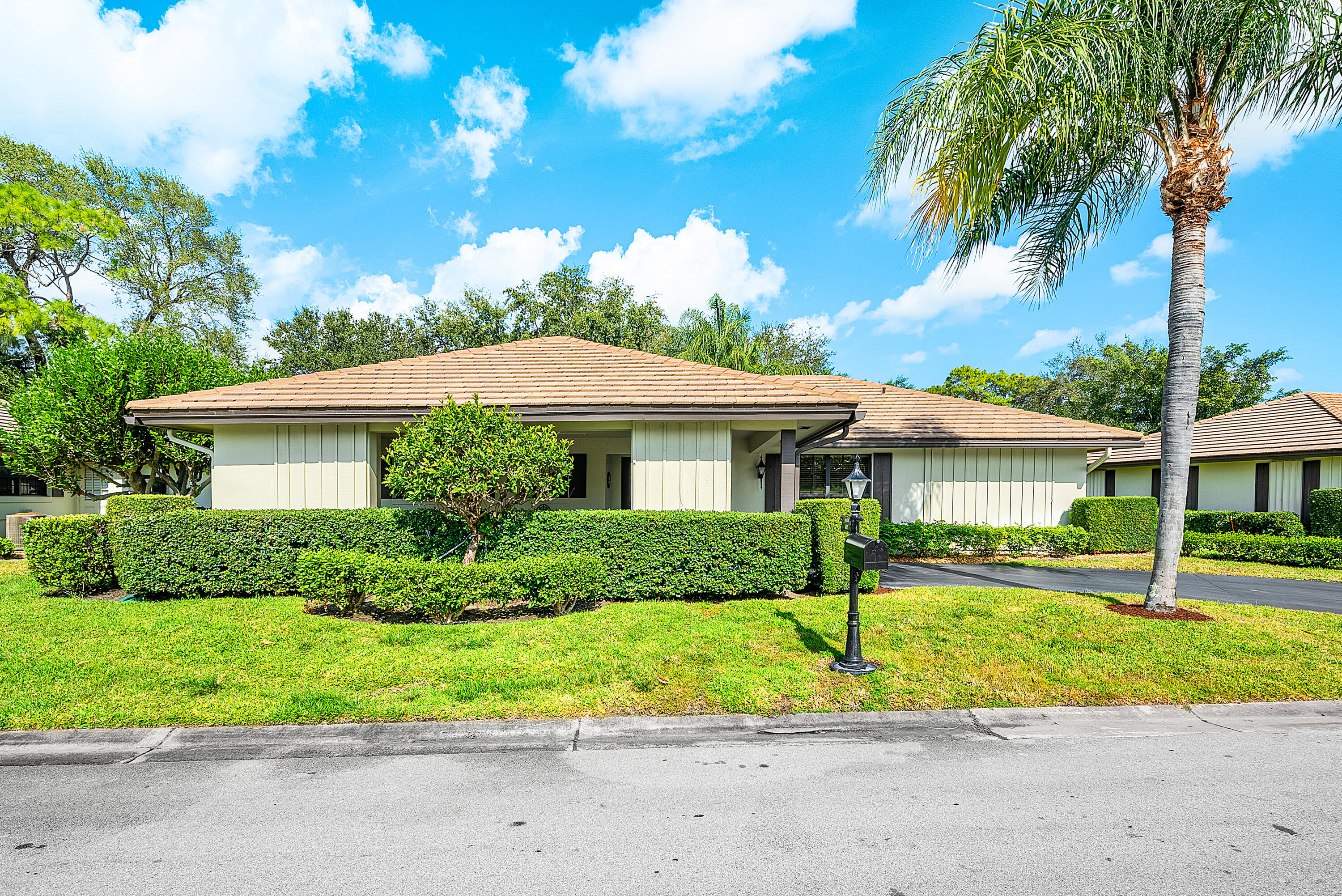 481 Forestview Drive Atlantis, FL 33462 - Photo 5 of 68 a front view of house with yard and green space