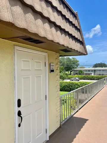 an aerial view of a house with swimming pool and outdoor seating