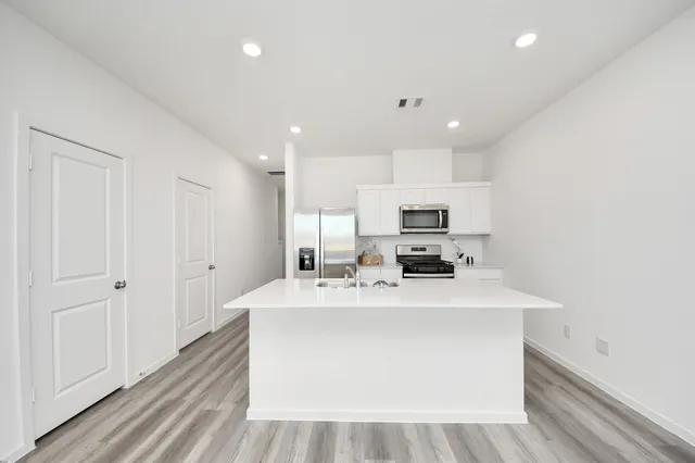 a view of a room with wooden floor and window