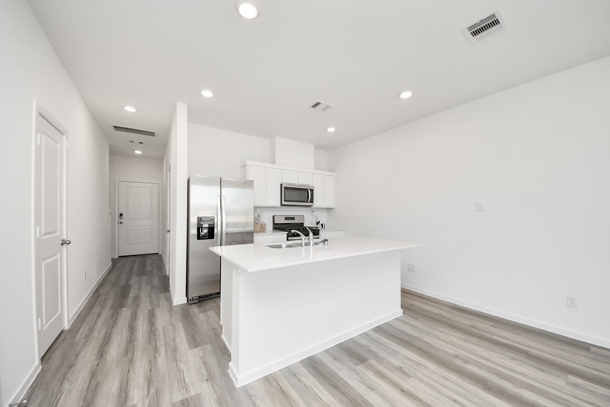 1006 Moon Drop Lane Houston, TX 77090 - Photo 12 of 38 a view of kitchen with sink microwave and refrigerator