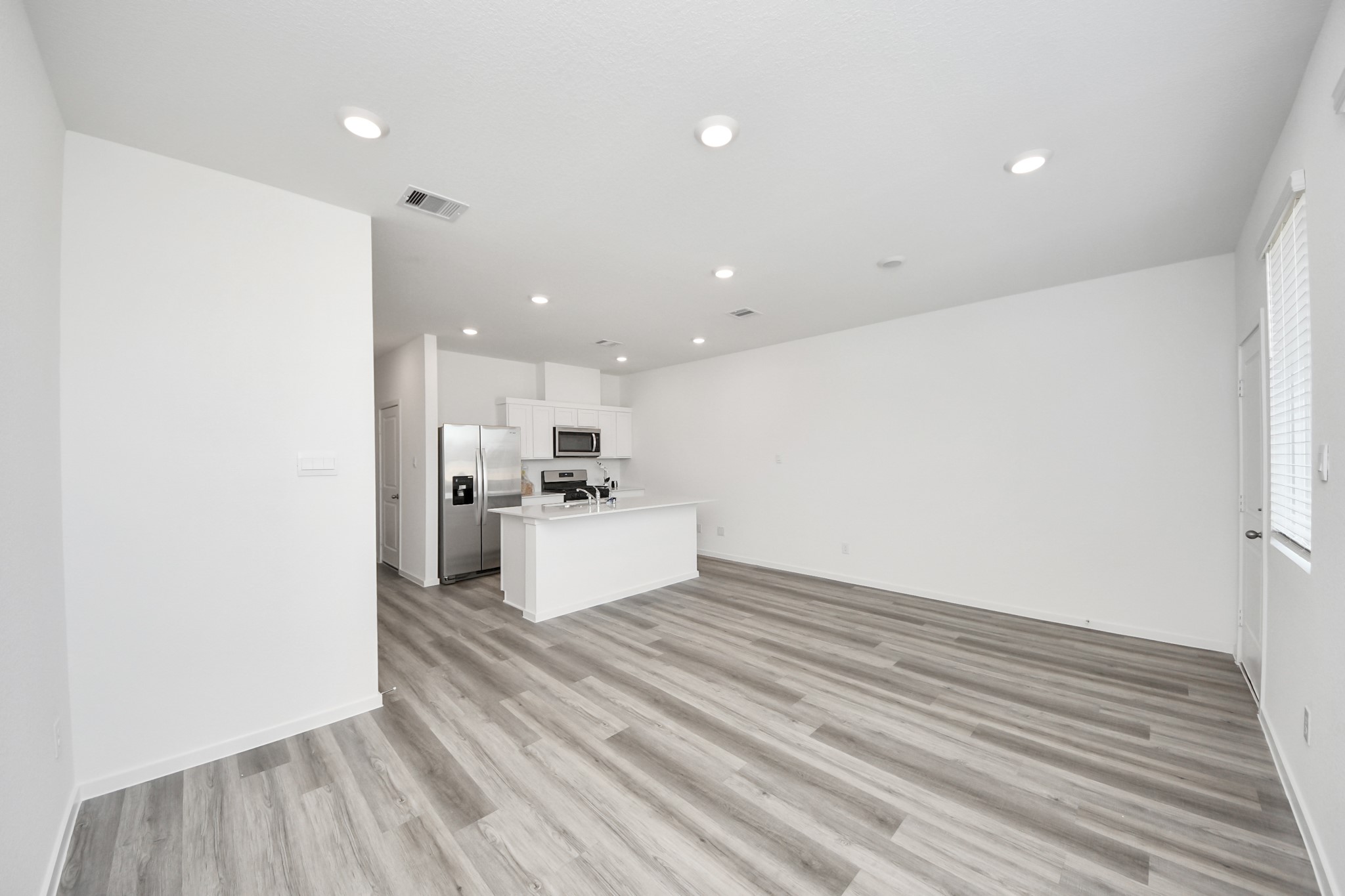 1006 Moon Drop Lane Houston, TX 77090 - Photo 14 of 38 a view of kitchen with sink microwave and refrigerator