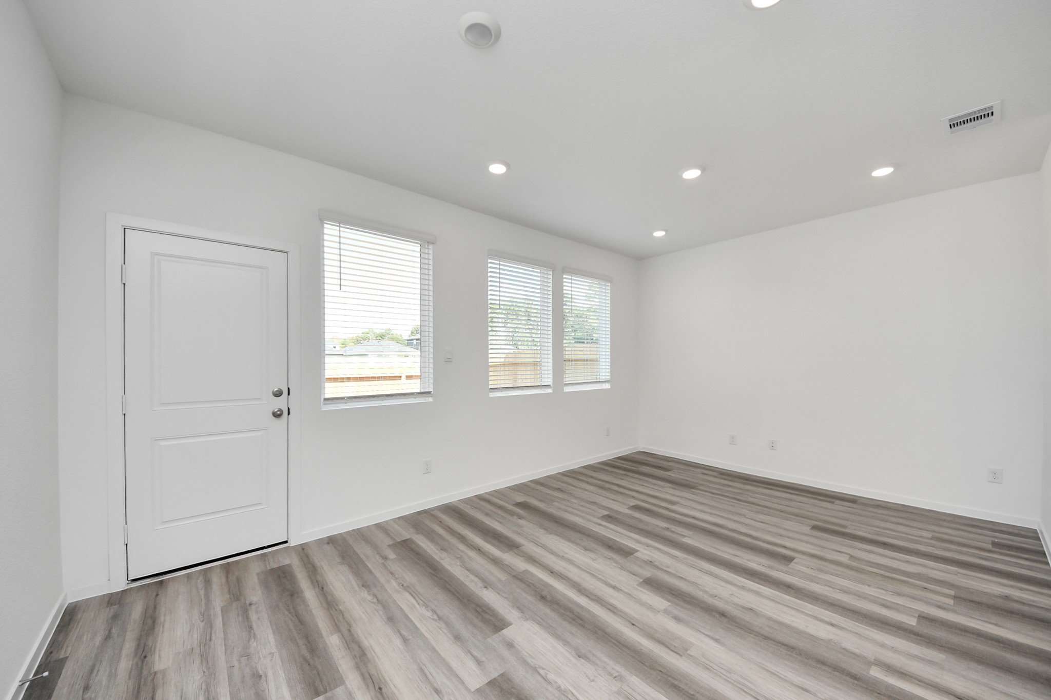 1006 Moon Drop Lane Houston, TX 77090 - Photo 16 of 38 a view of empty room with wooden floor and fan