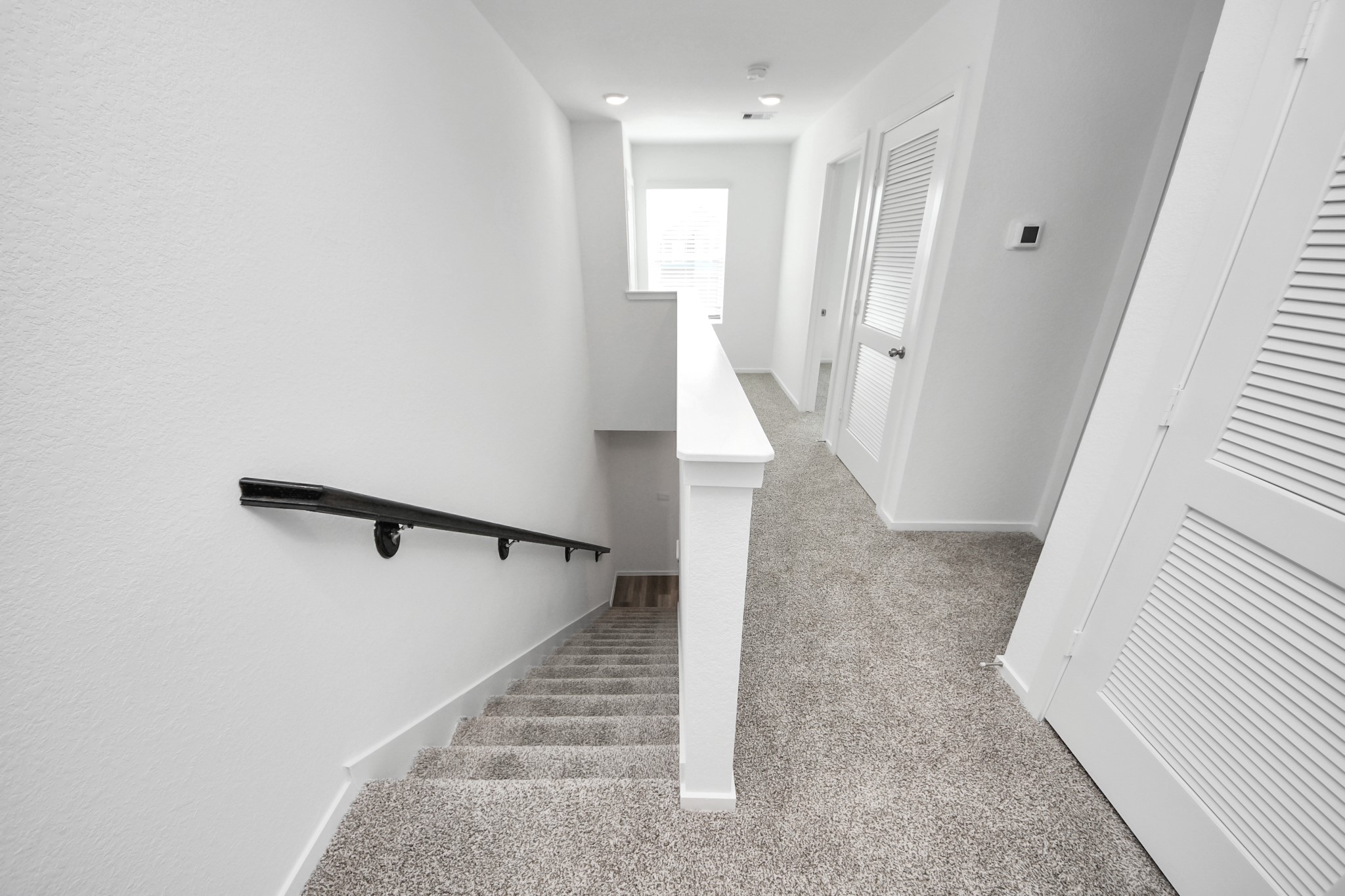 1006 Moon Drop Lane Houston, TX 77090 - Photo 25 of 38 a view of a hallway with staircase