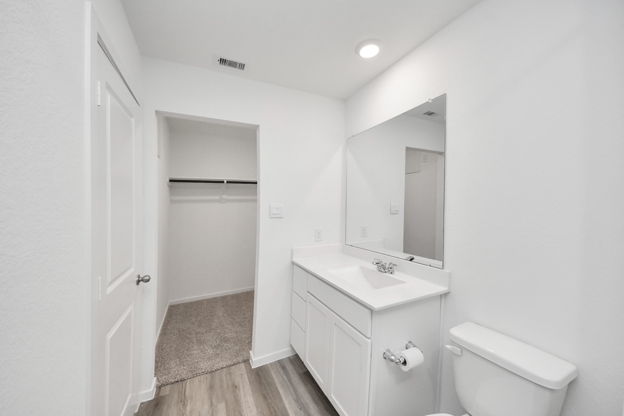 1006 Moon Drop Lane Houston, TX 77090 - Photo 28 of 38 a bathroom with a toilet sink and mirror