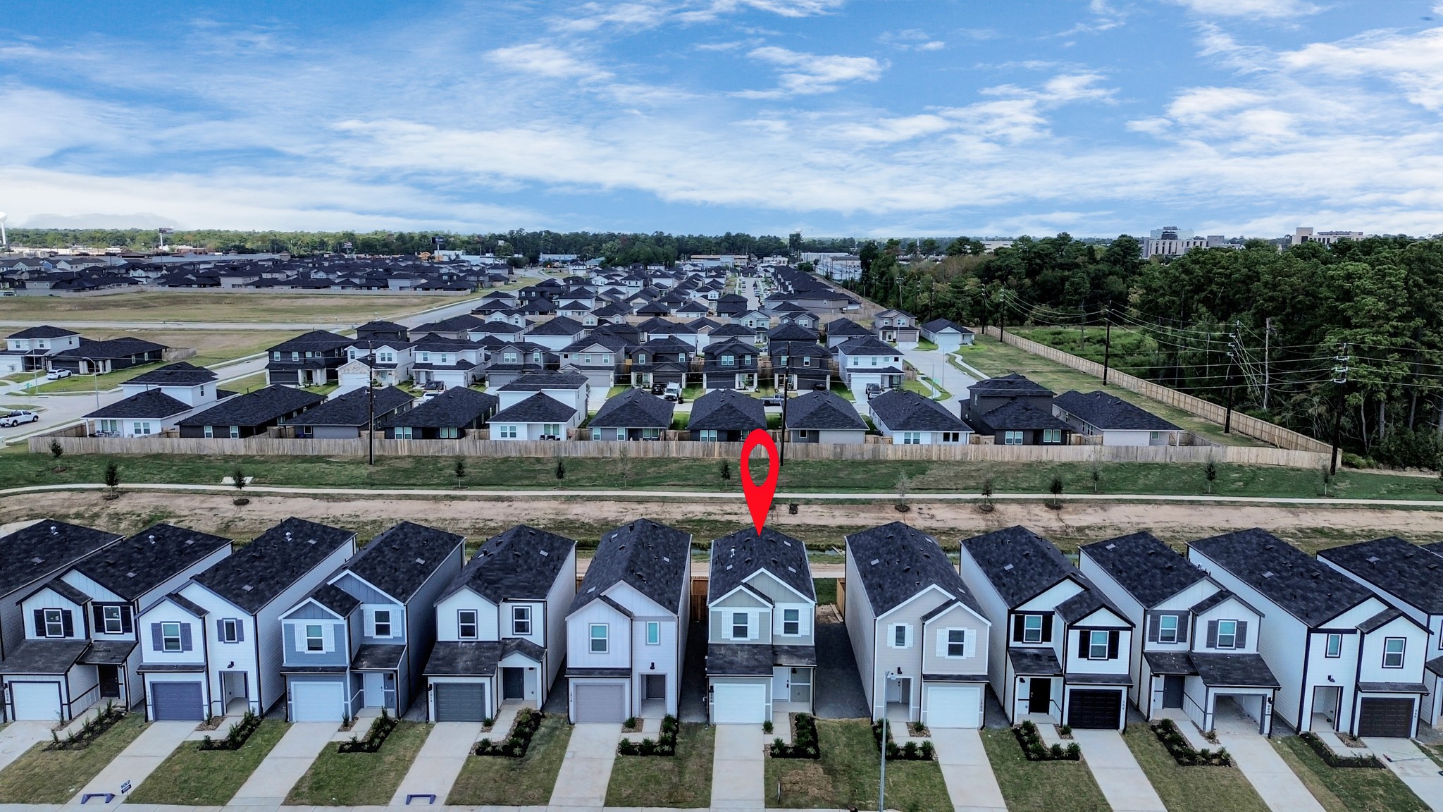 1006 Moon Drop Lane Houston, TX 77090 - Photo 3 of 38 an aerial view of a house with a garden and lake view