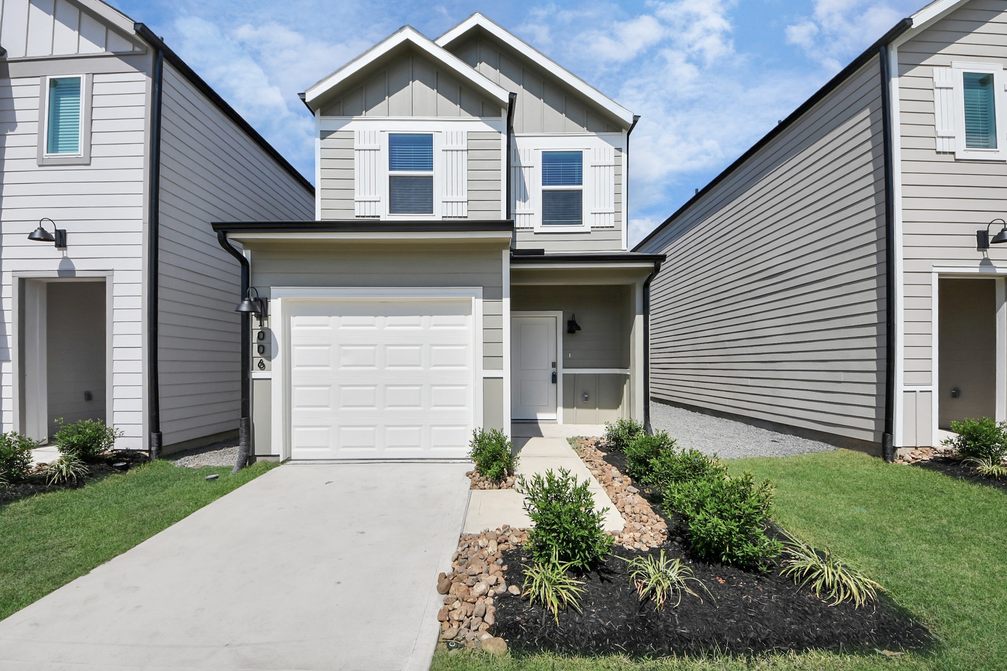 1006 Moon Drop Lane Houston, TX 77090 - Photo 38 of 38 a front view of a house with a yard and garage