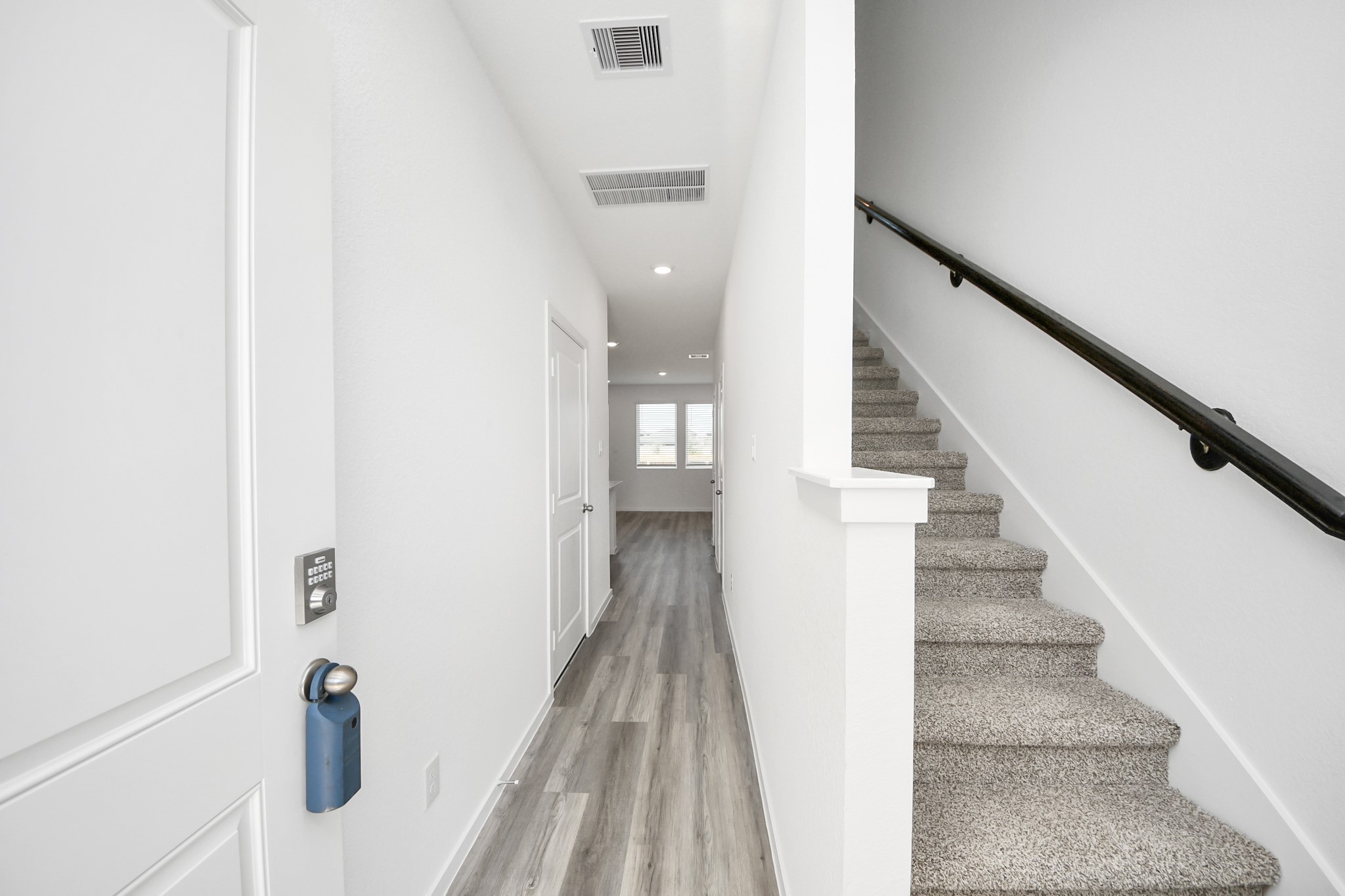 1006 Moon Drop Lane Houston, TX 77090 - Photo 5 of 38 a view of staircase with white walls