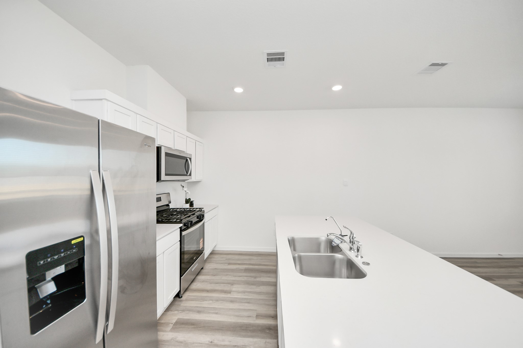 1006 Moon Drop Lane Houston, TX 77090 - Photo 7 of 38 a kitchen with a sink and refrigerator