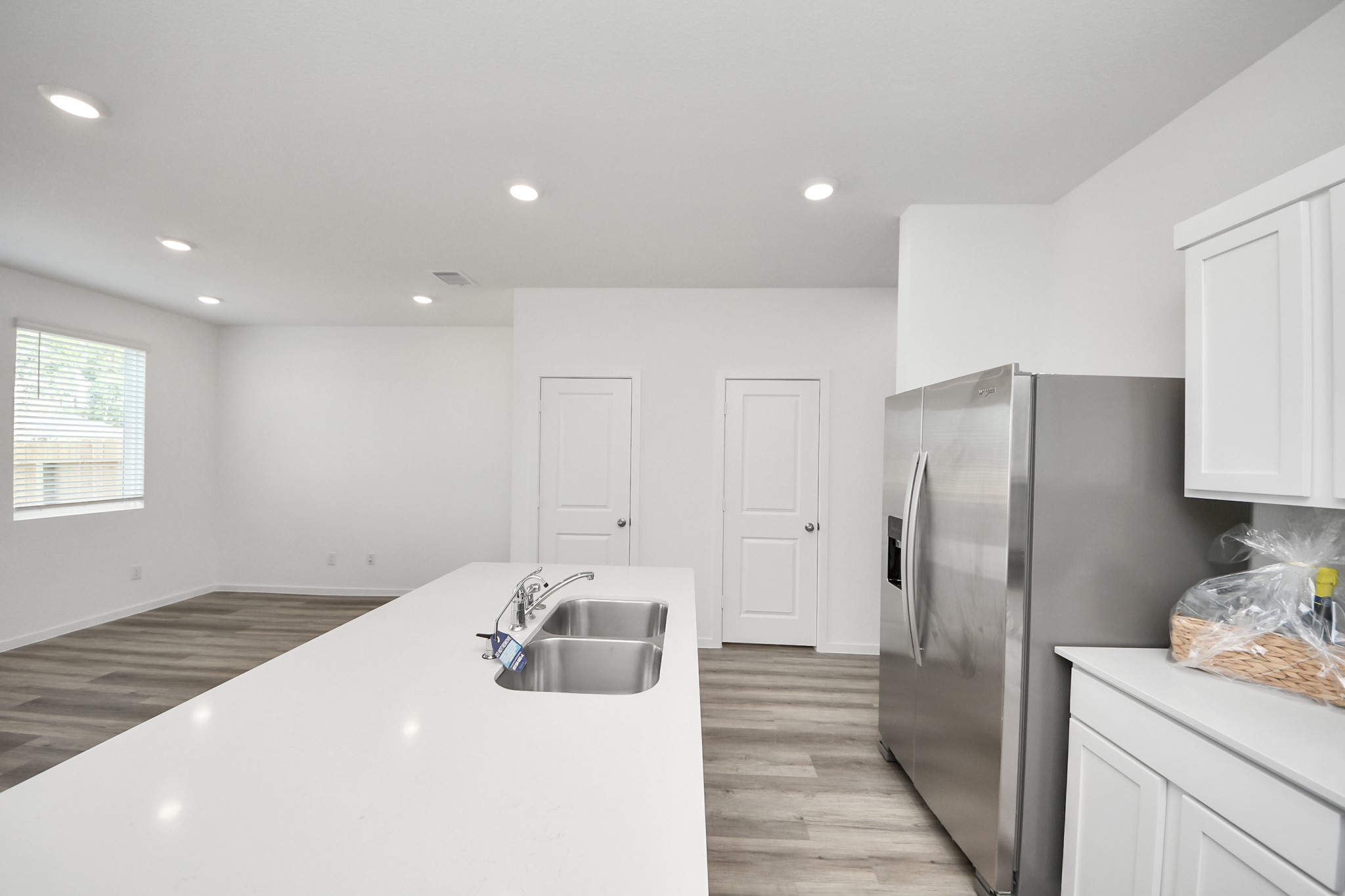1006 Moon Drop Lane Houston, TX 77090 - Photo 9 of 38 a kitchen with stainless steel appliances a refrigerator sink and cabinets