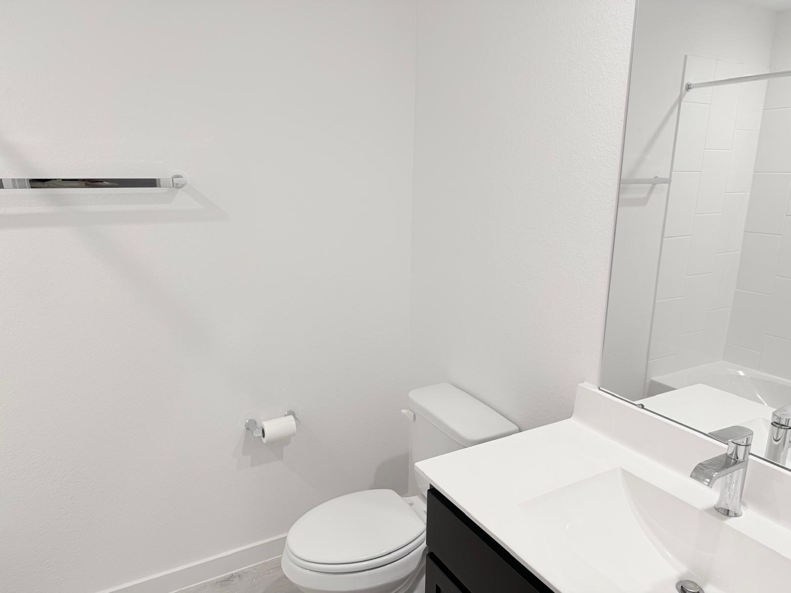 5111 Hunters Trail Fresno, TX 77545 - Photo 13 of 16 a white toilet sitting next to a bathroom sink