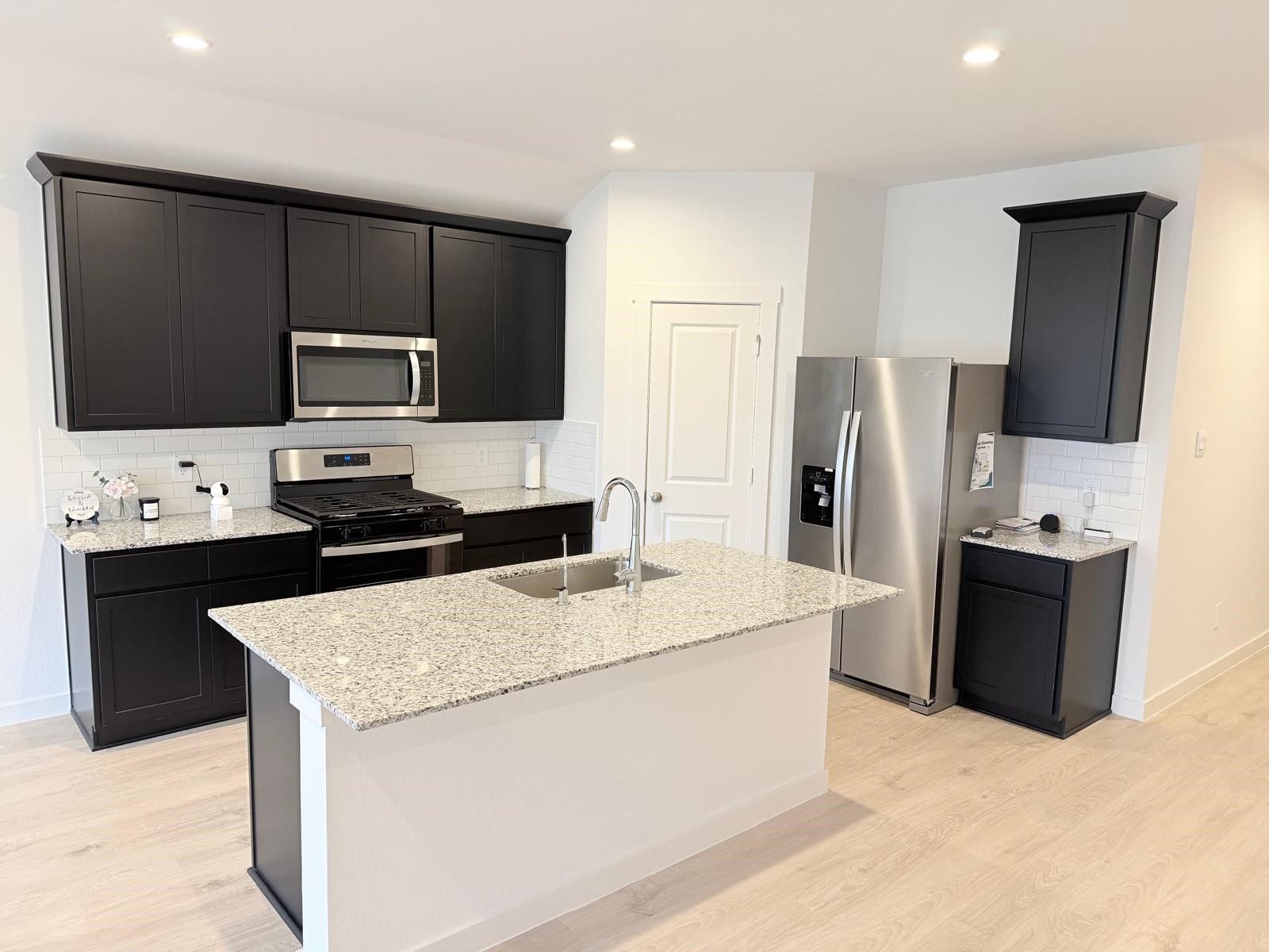 5111 Hunters Trail Fresno, TX 77545 - Photo 3 of 16 a kitchen with stainless steel appliances wooden cabinets a refrigerator and a stove