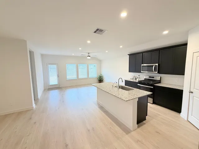 a kitchen with a sink and a microwave