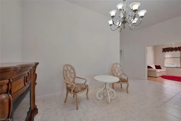 a view of a dining room with furniture and chandelier