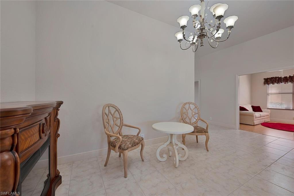 20241 Rookery Drive Estero, FL 33928 - Photo 13 of 33 Living area featuring a notable chandelier