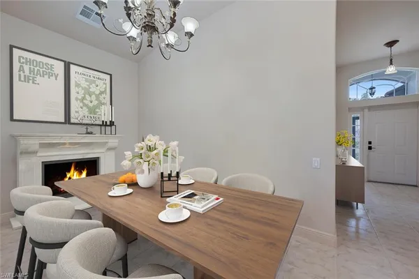 a view of a dining room with furniture and chandelier