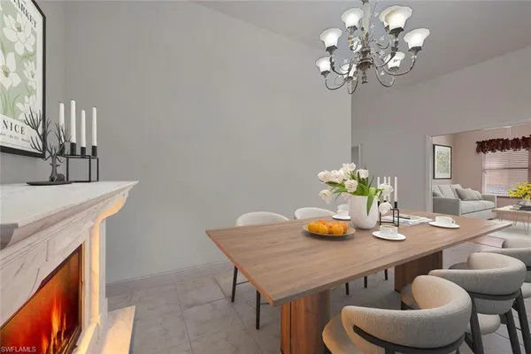 a view of a dining room with furniture and chandelier