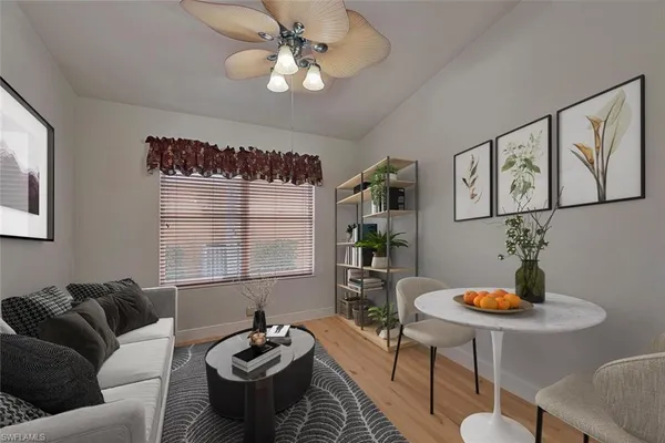 a living room with furniture a window and a table