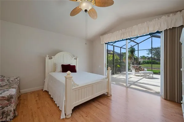 a bedroom with a bed and a large window with outer view