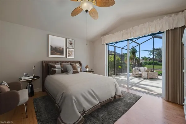 a bedroom with a large bed and a large window