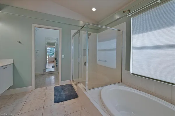 a bathroom with a shower and a sink
