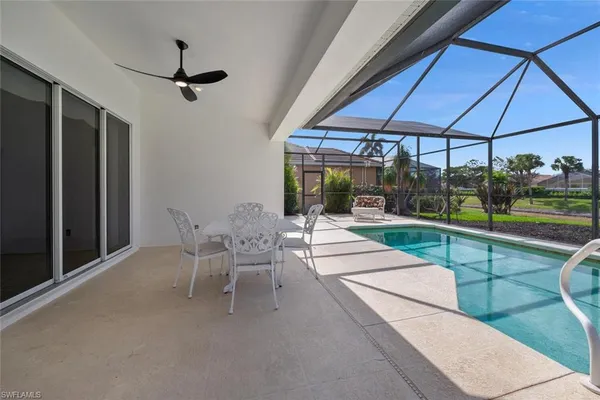 a view of a patio with a table and chairs under an umbrella