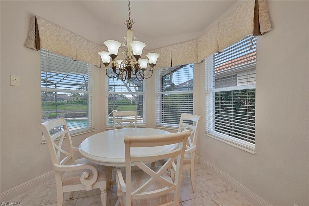 20241 Rookery Drive Estero, FL 33928 - Photo 6 of 33 Tiled dining space with a chandelier