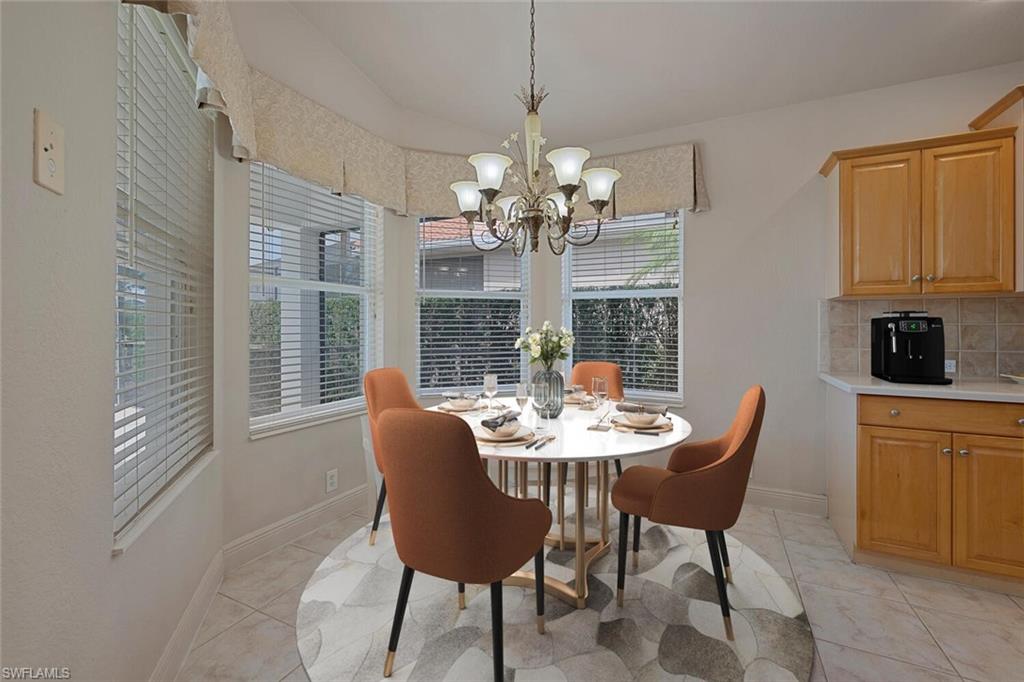 20241 Rookery Drive Estero, FL 33928 - Photo 7 of 33 Virtually Staged Dining room with a chandelier, baseboards, and light tile patterned floors