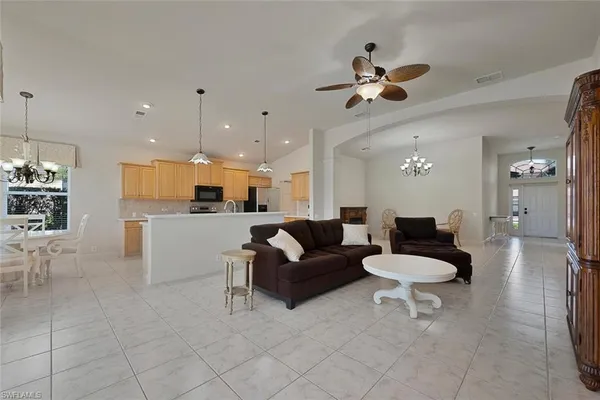 a living room with furniture and kitchen view
