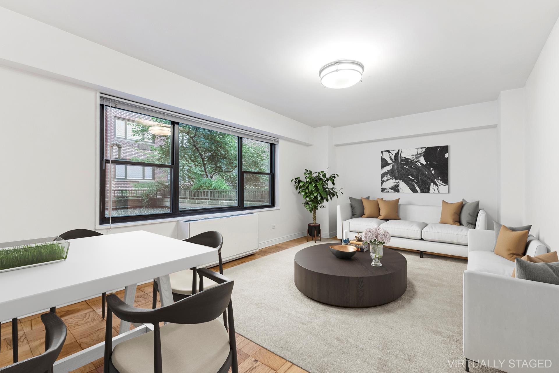 a living room with furniture and a potted plant