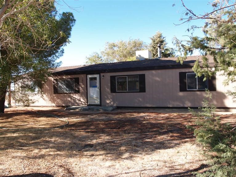 7878 Goss Road Phelan, CA 92371 - Photo 1 of 1 a view of a house with a bed and wooden fence