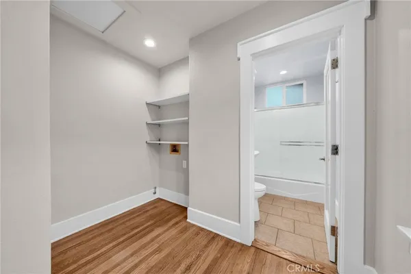 a view of empty room with wooden floor