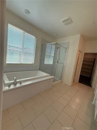 a spacious bathroom with a bathtub and a sink