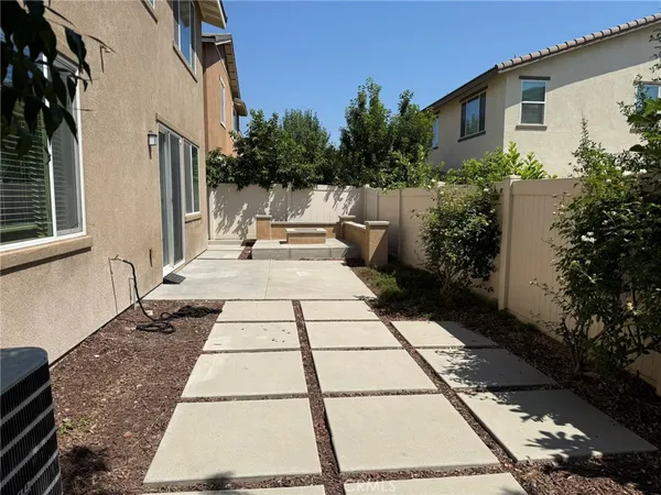 a view of a backyard with sitting area