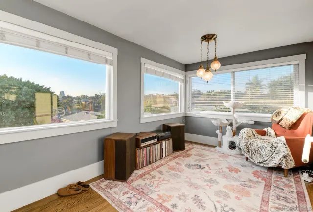 a bedroom with furniture and a large window