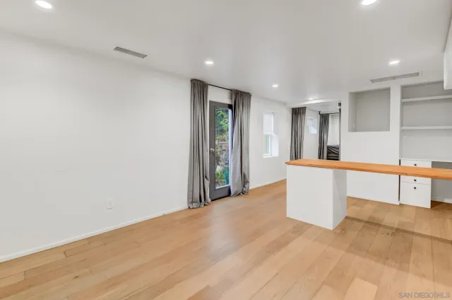 a view of a kitchen with a refrigerator and a sink